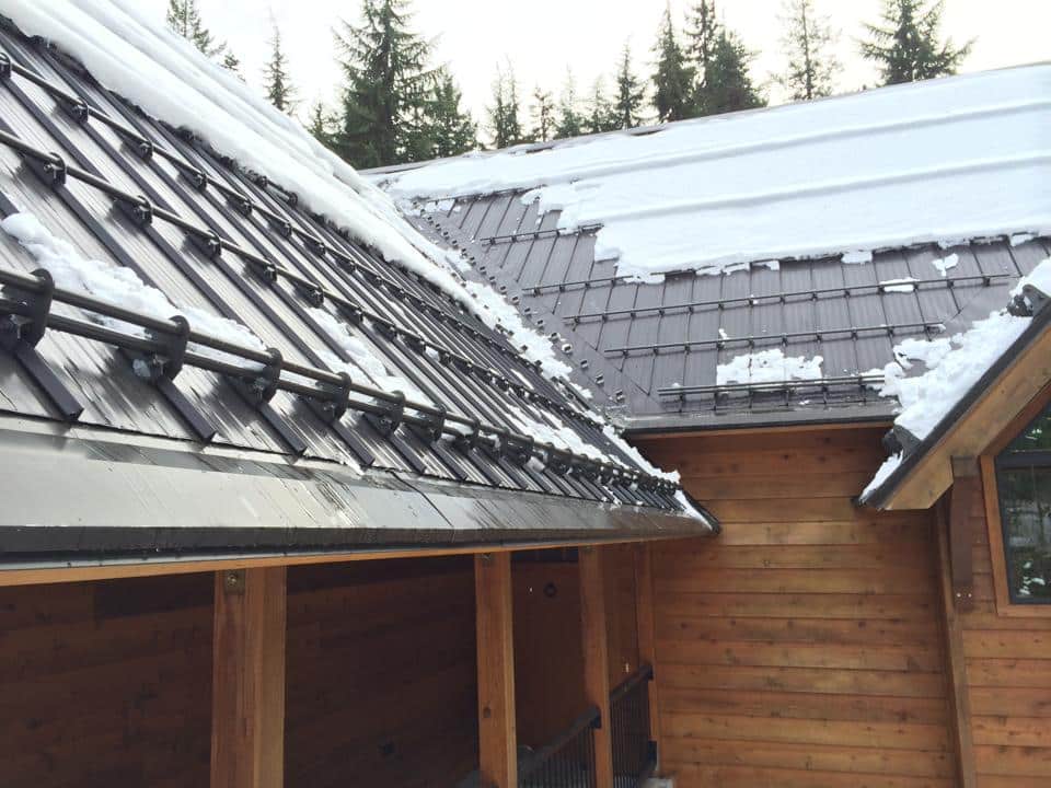 snow guards on roof with snow