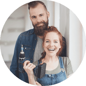 happy husband and wife holding a drill