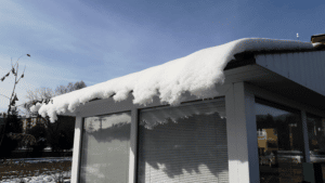 snow overflowing on garage